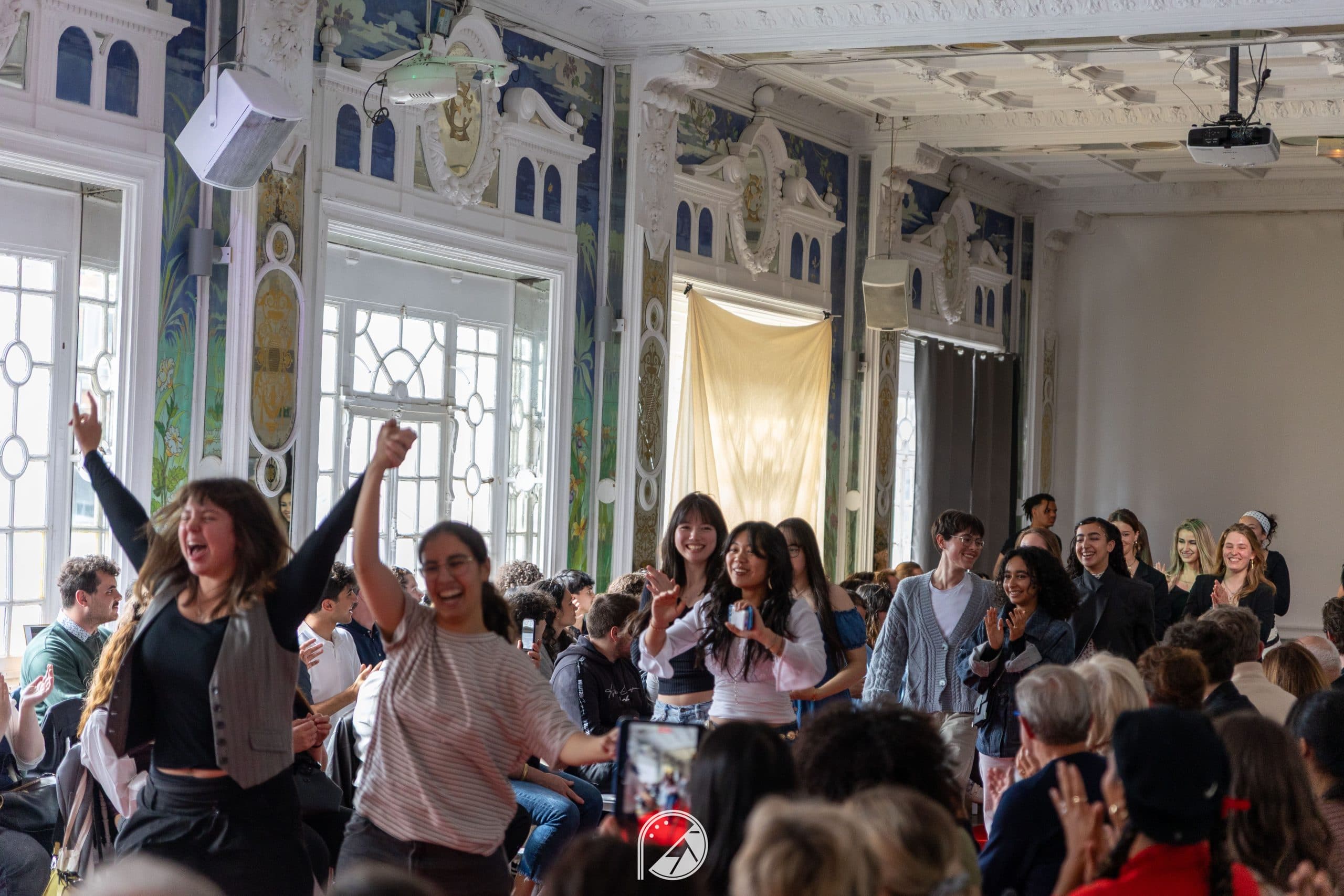 Models and the creative team walking out together in celebration through the Salon des Miroirs